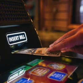 Cash being inserted into a slot machine