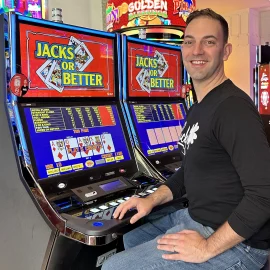 Brian Christopher sits at a video poker machine
