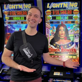 Brian Christopher gestures to a bank of slot machines