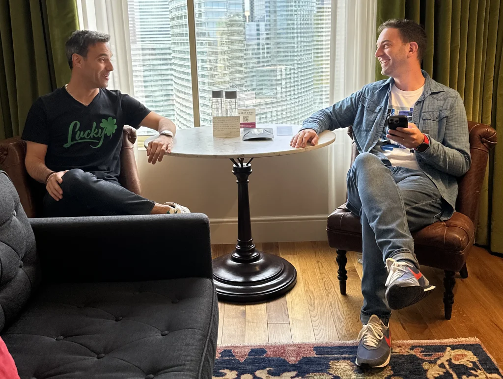 Brian and Marco sit at a table in a NoMad suite