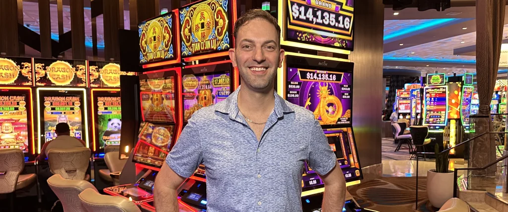 Brian Christopher stands near slot machines