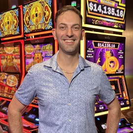 Brian Christopher stands near slot machines
