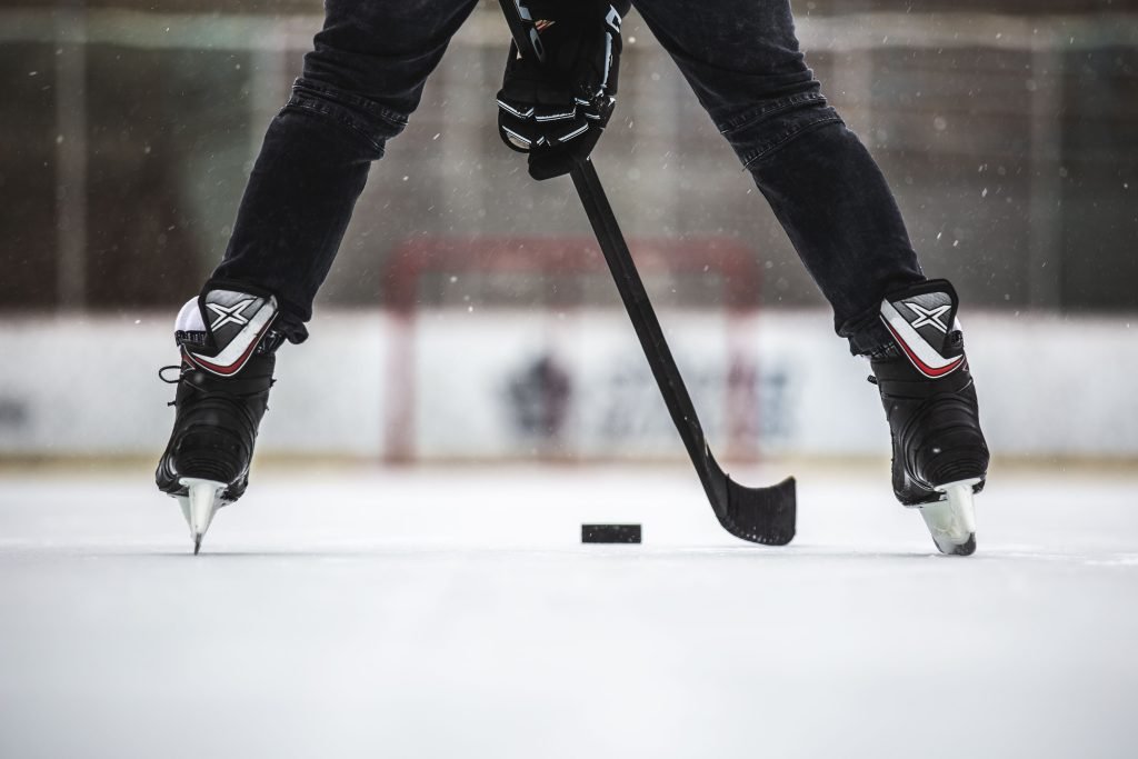 Hockey player about to hit puck