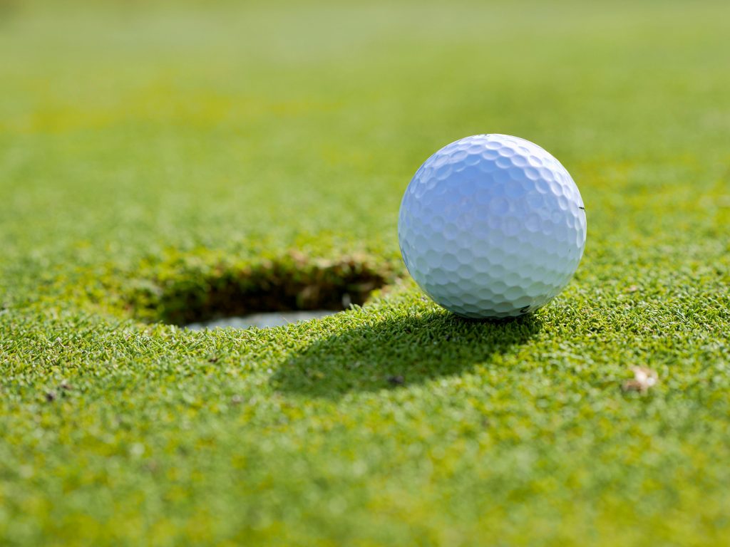 Golfball going into hole