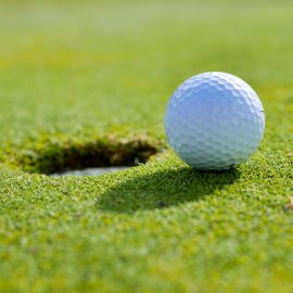 Golfball going into hole