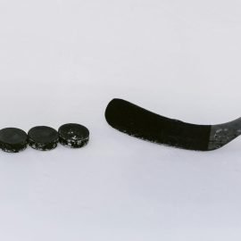 Hockey stick with hockey pucks square