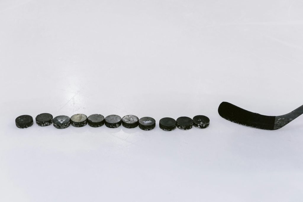 Hockey stick with hockey pucks