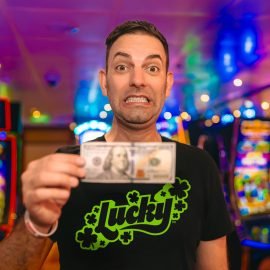 Brian holding a $100 bill