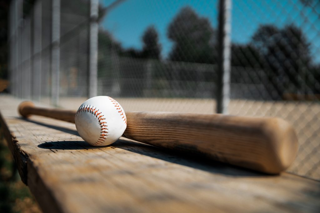 Baseball and bat on a bench