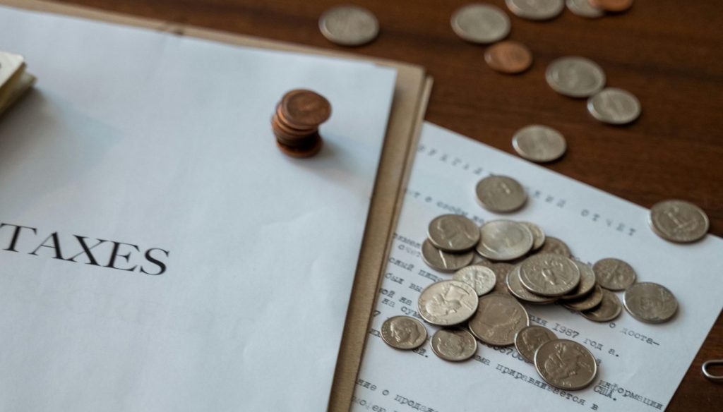 Tax document with coins on table