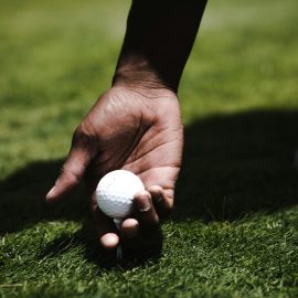 Person holding golf ball