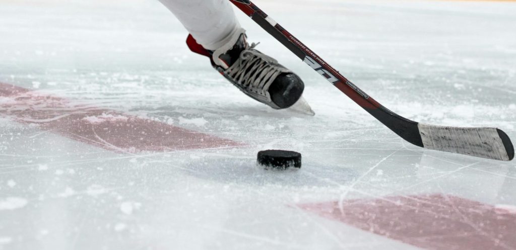 Hockey player hitting the puck