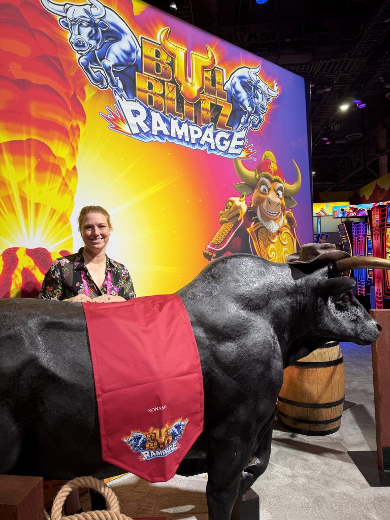 Courtney stands in front of a Bull Blitz Rampage display at the Konami booth during the Global Gaming Expo 2026 in Las Vegas, Nevada.
